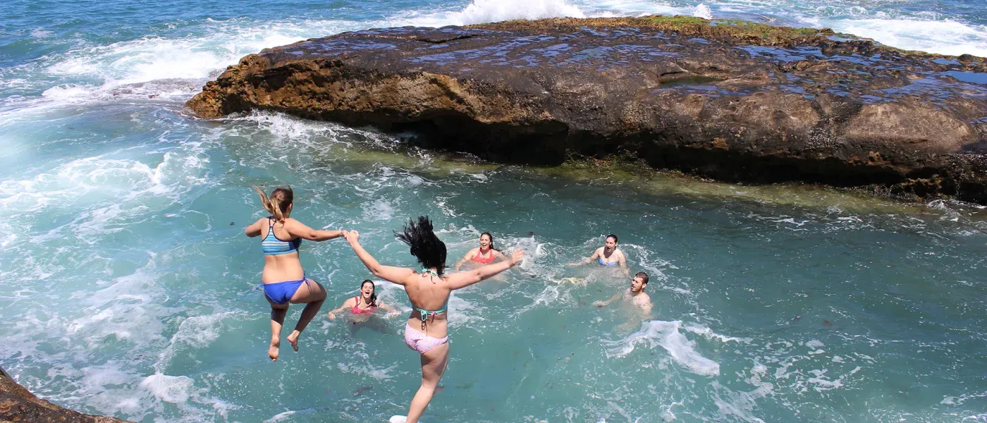 Students jump intro the sea during an excursion to Cherifian